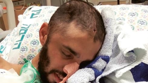 משה בבית החולים לאחר שנפצע. המשפחה מלווה אותו 