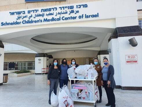 צוות בית הספר "לאה גולדברג" לצד התחפושות והמשחקים שנרכשו