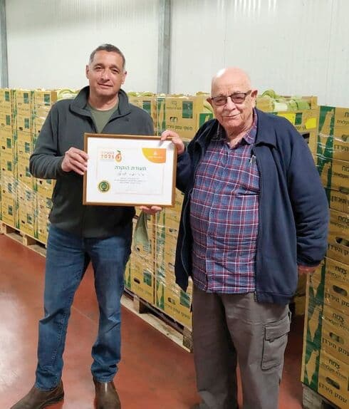 ד"ר יאיר ישראלי מקבל את האות ממנכ"ל ארגון מגדלי הפירות ירון בלחסן 