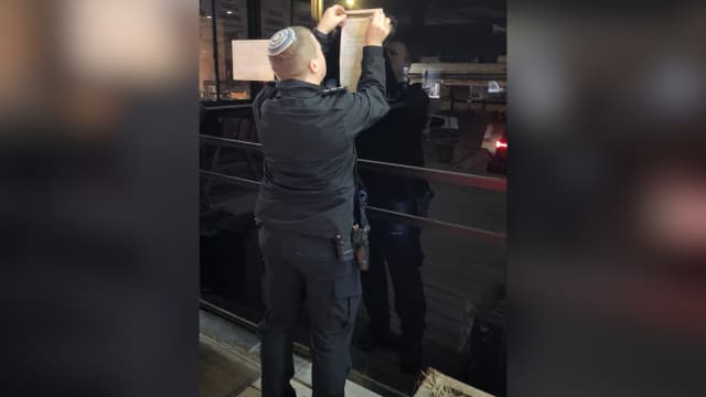 שוטר תולה צו סגירה בבית הקפה