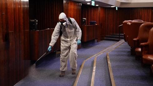 Un trabajador procede a la esterilización de la Knesset