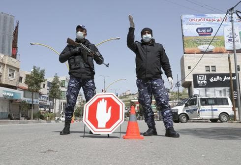Fuerzas de seguridad palesetina controlan la entrada a principal a Hebrón. 