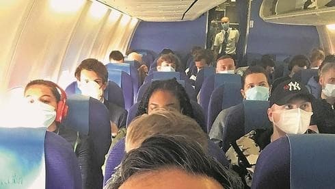 Pasajeros con máscaras en un vuelo internacional 