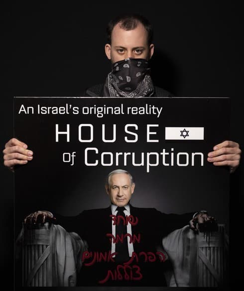 Shachar Oren en una protesta contra Benjamin Netanyahu frente a su residencia de Jerusalén en Jerusalén. El letrero dice: 'Soborno, fraude, abuso de confianza, submarino', una referencia a los problemas legales del primer ministro. 