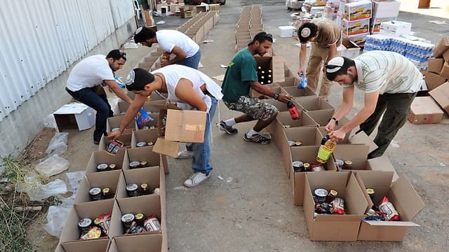 Voluntarios israelíes trabajan en la distribución y separación en un banco de alimentos. (Shutterstock) Voluntarios israelíes trabajan en la distribución y separación en un banco de alimentos.