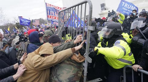 La policía lucha por detener a los manifestantes pro-Trump en la entrada del Capitolio. 