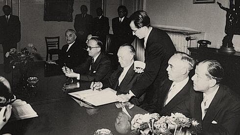 El canciller de Alemania Occidental, Konrad Adenauer, firma el acuerdo de reparaciones entre su país e Israel, 10 de septiembre de 1952. (Museo del Holocausto de Estados Unidos) El canciller de Alemania Occidental, Konrad Adenauer, firma el acuerdo de reparaciones entre su país e Israel, 10 de septiembre de 1952.