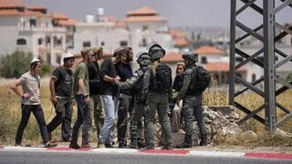 Fuerzas de seguridad con colonos israelíes. 
