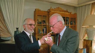 El rey Hussein enciende un cigarrillo para Rabin después de la firma del acuerdo de paz. 