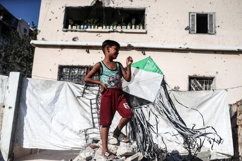 طفل يحمل طائرة ورقية في غزة